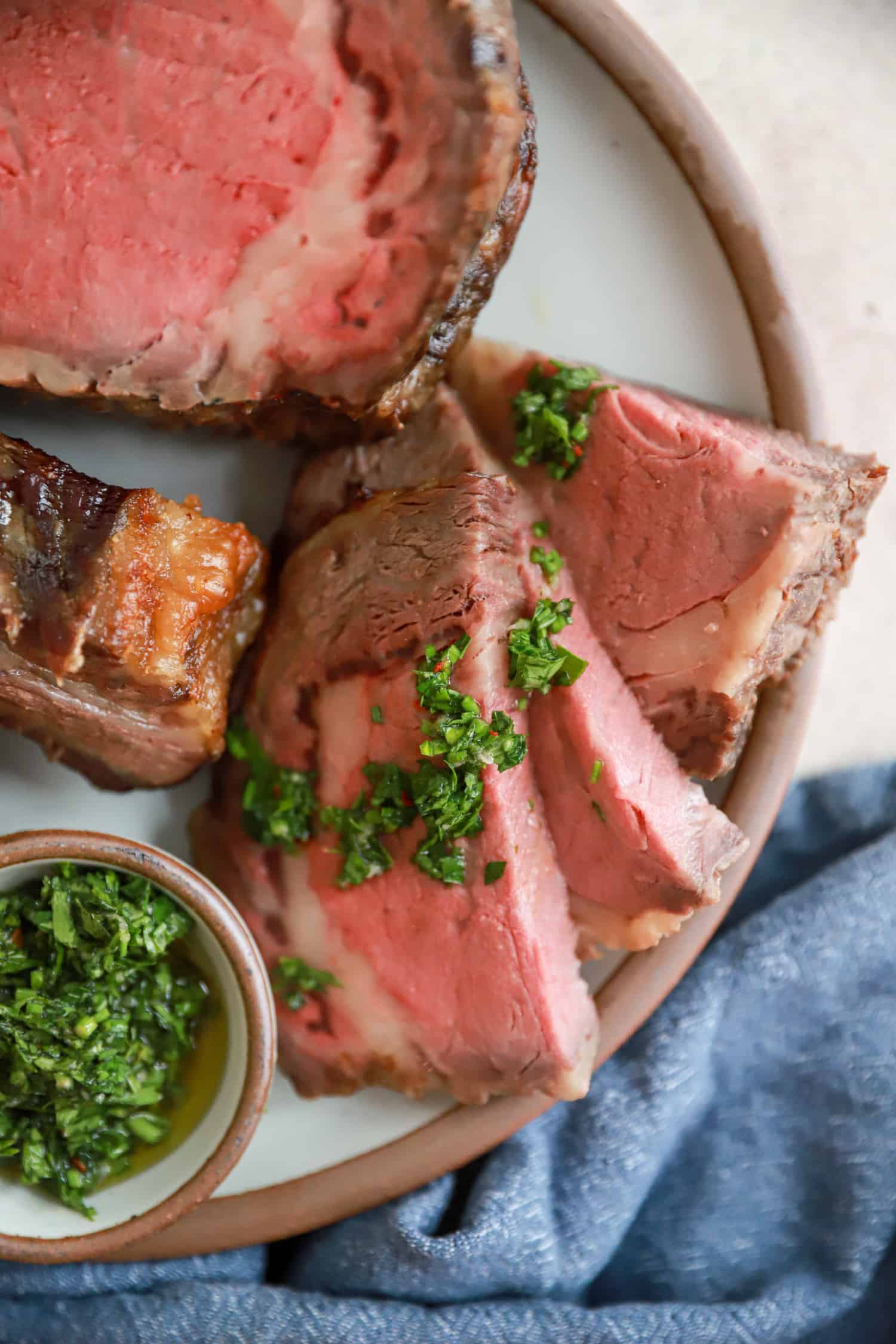 slices of rib roast topped with fresh chimichurri.
