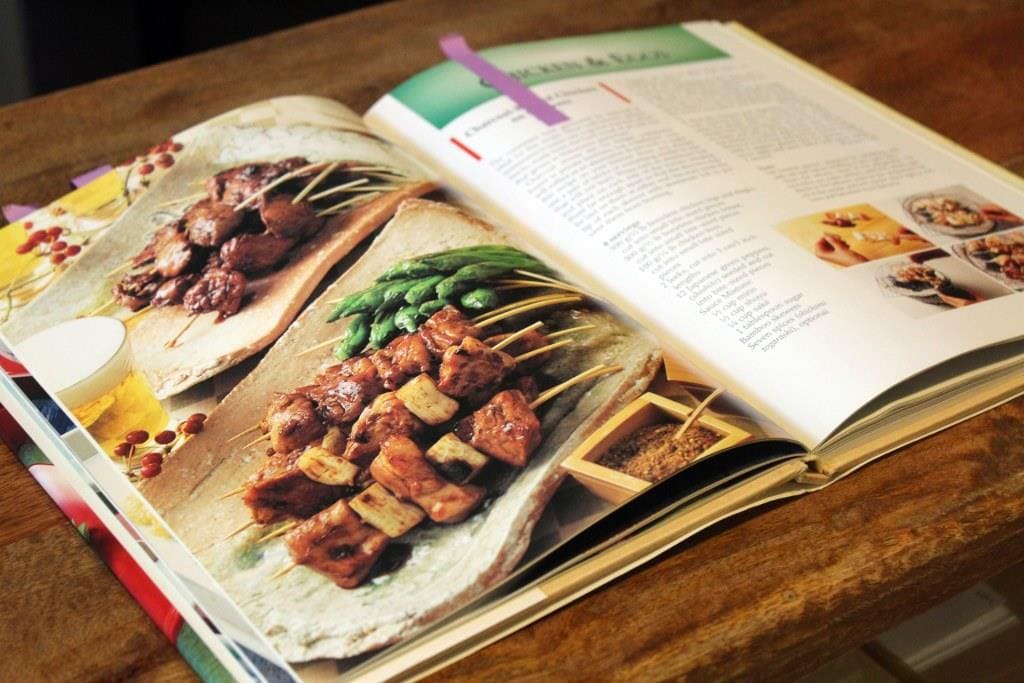 Simple And Delicious Japanese cooking book open to yakitori recipe page.