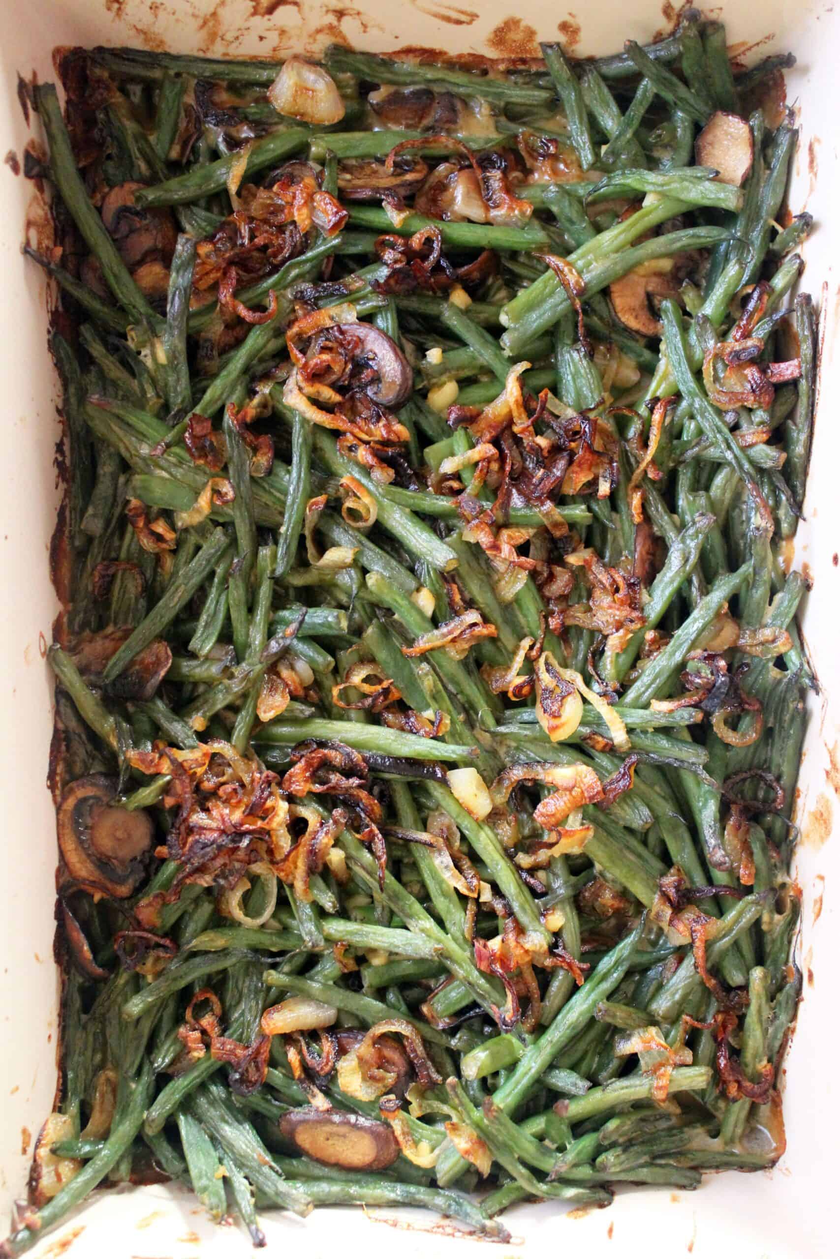 Top view of healthy green bean casserole with fresh shallot topping.