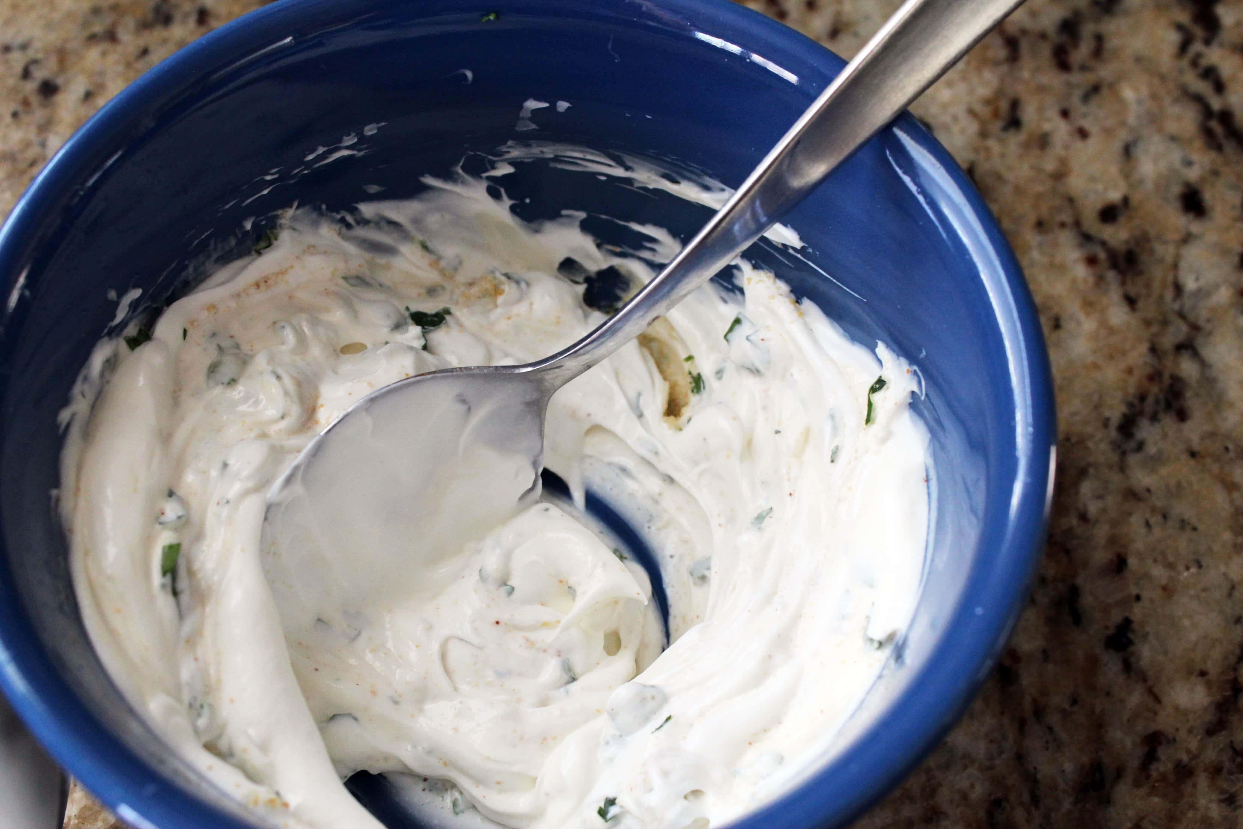 blue bowl with silver spoon and ranch dip.