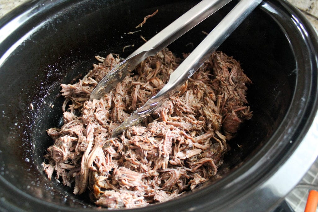 shredded beef with drippings in slow cooker