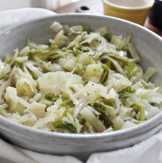 Serving bowl of stewed cabbage with butter.