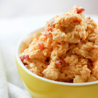 Yellow bowl piled with no cream cheese pimento cheese classic southern style.
