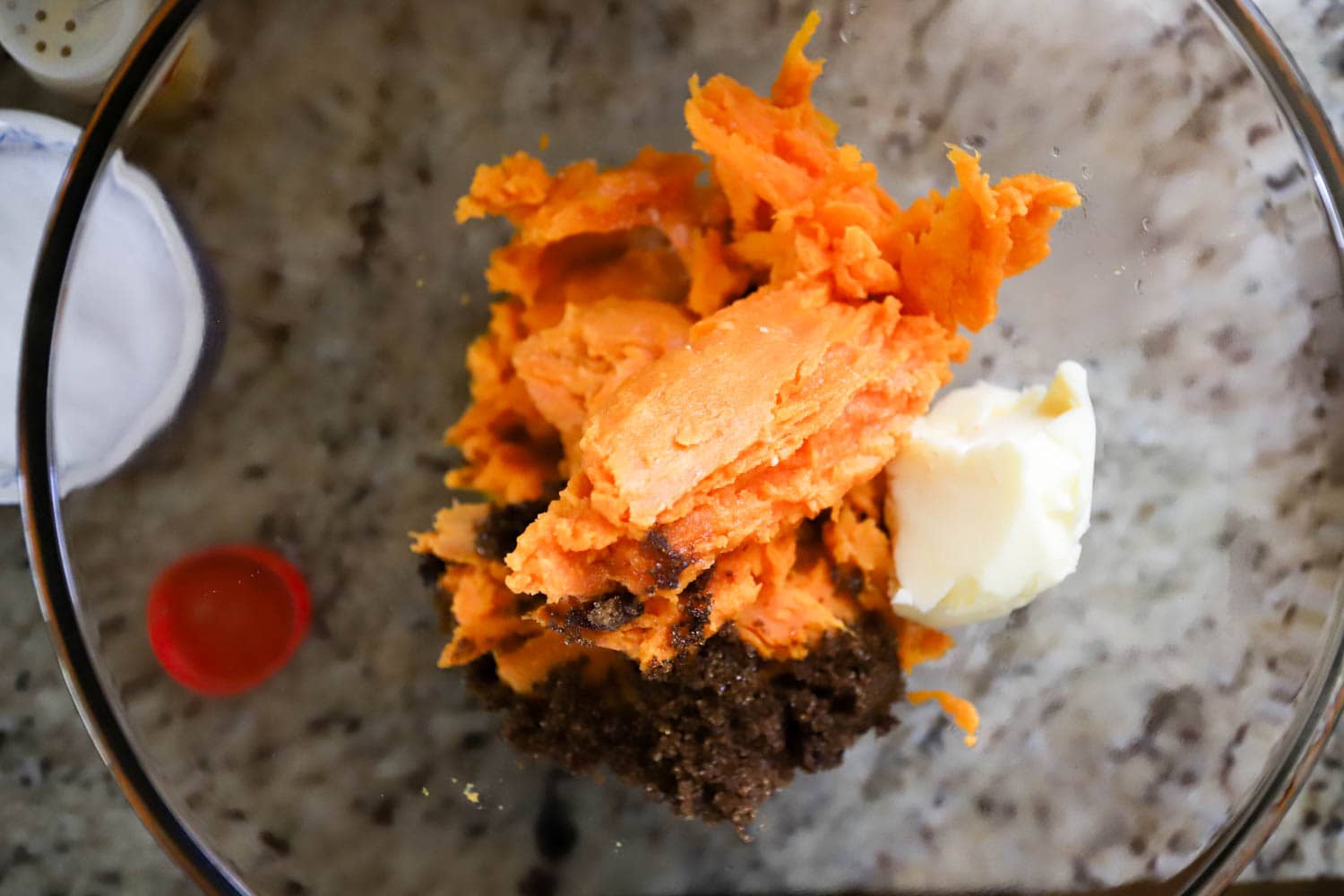 clear glass bowl with ingredients for healthy sweet potato casserole.