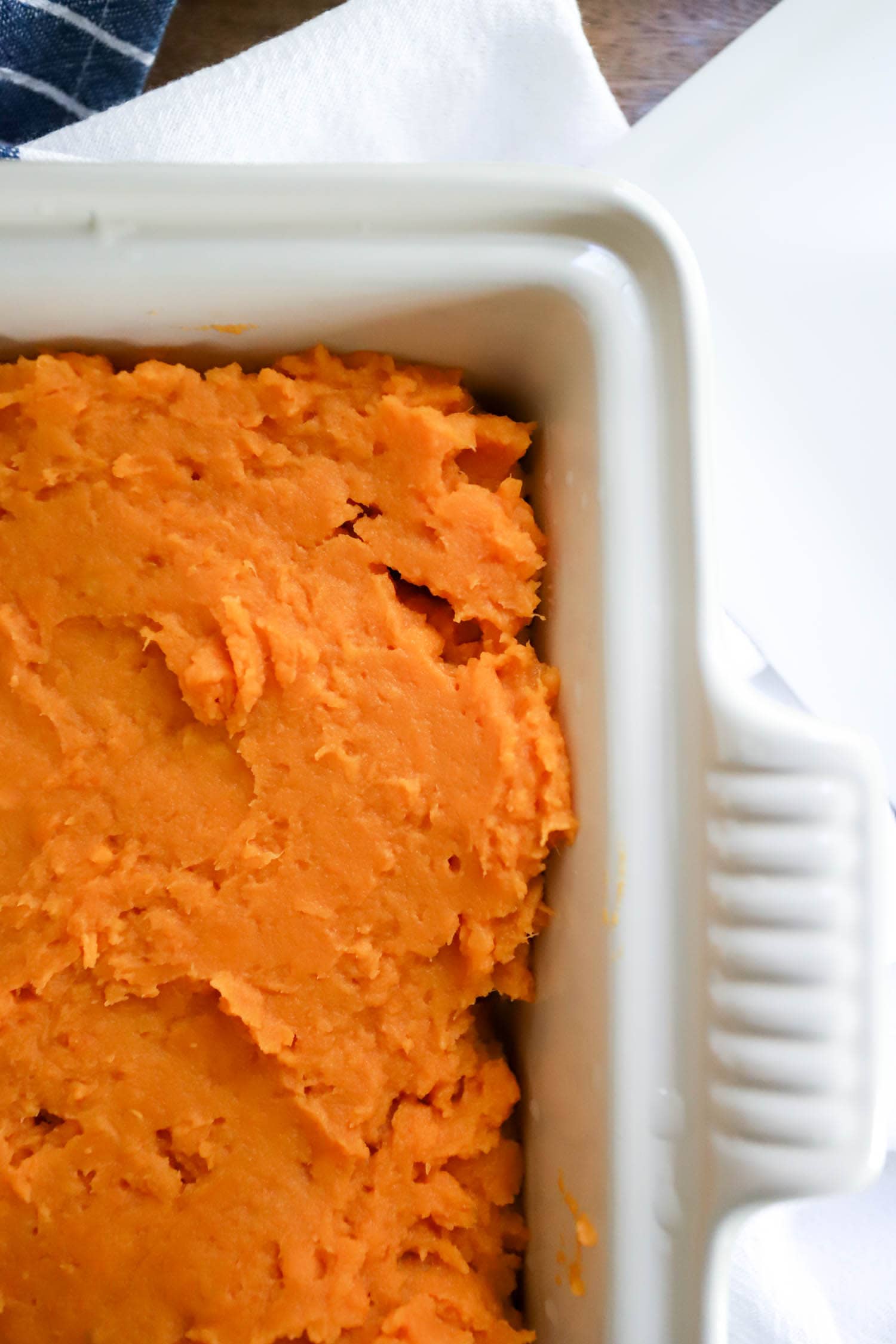 white square dish of mashed sweet potato casserole.