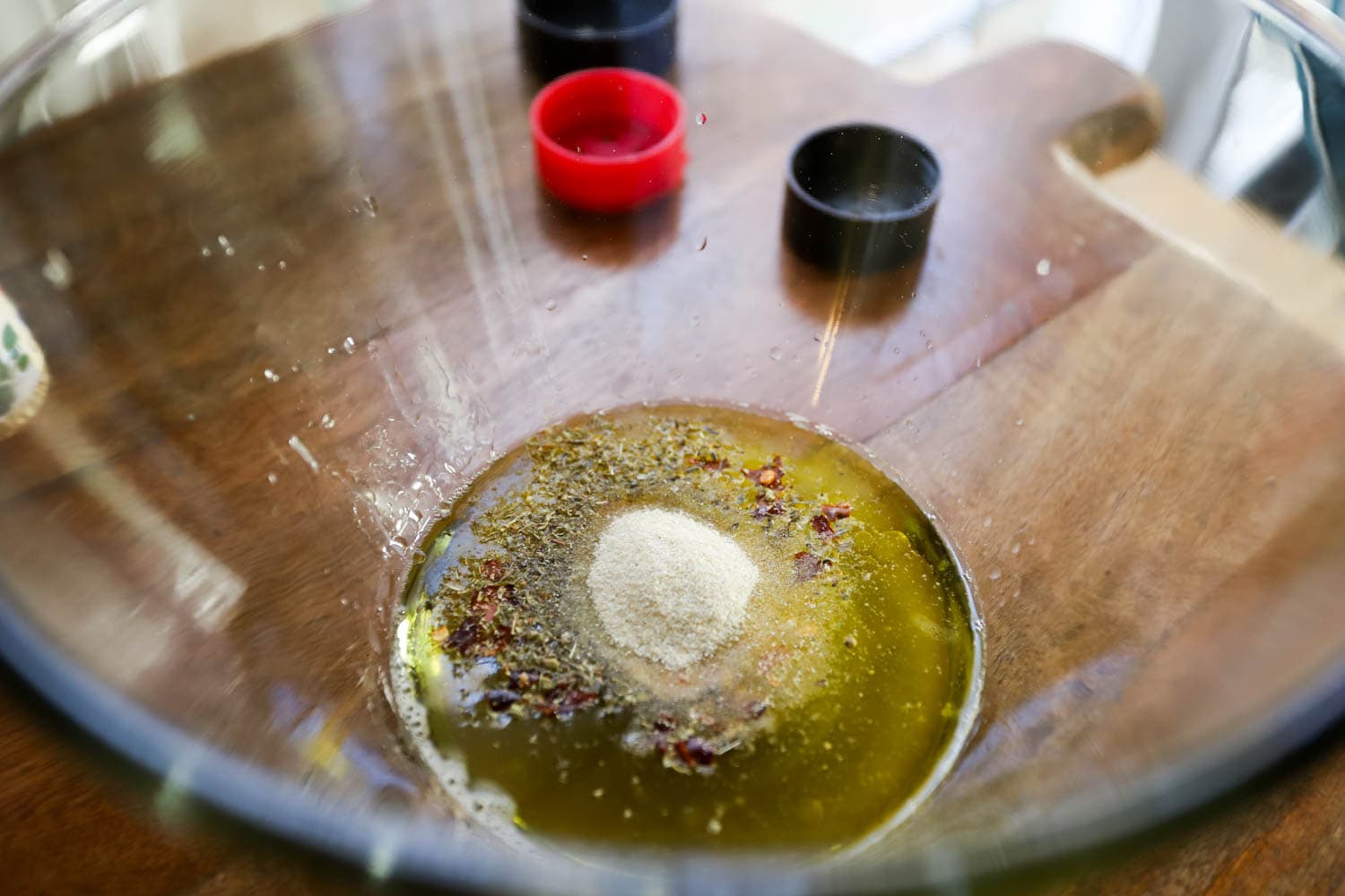 marinade ingredients with spices in the bottom of a  glass bowl.