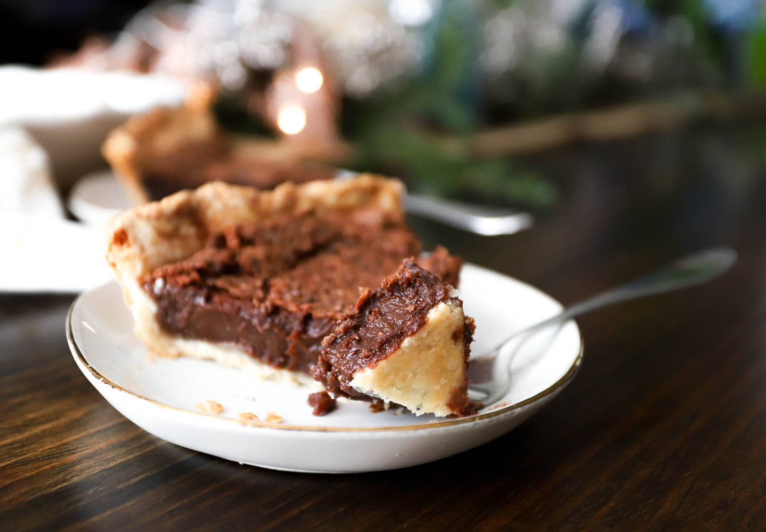 slice of old-fashioned chocolate chess pie with a bite on the end of a fork.