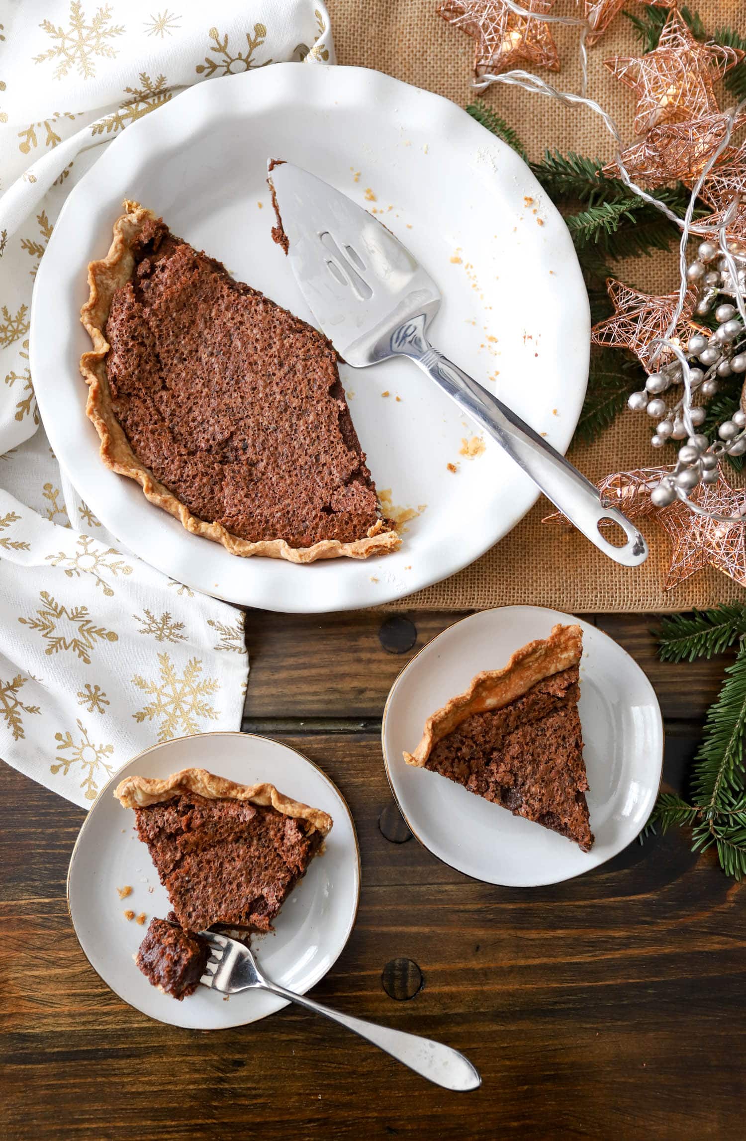 chocolate chess pie with two smaller plates containing one piece of pie each.