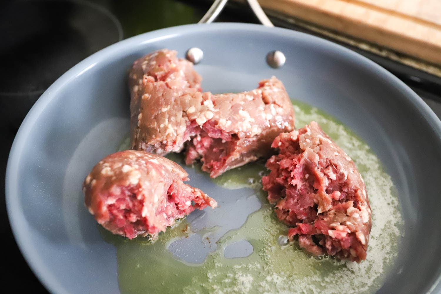 uncooked ground beef in nonstick skillet.