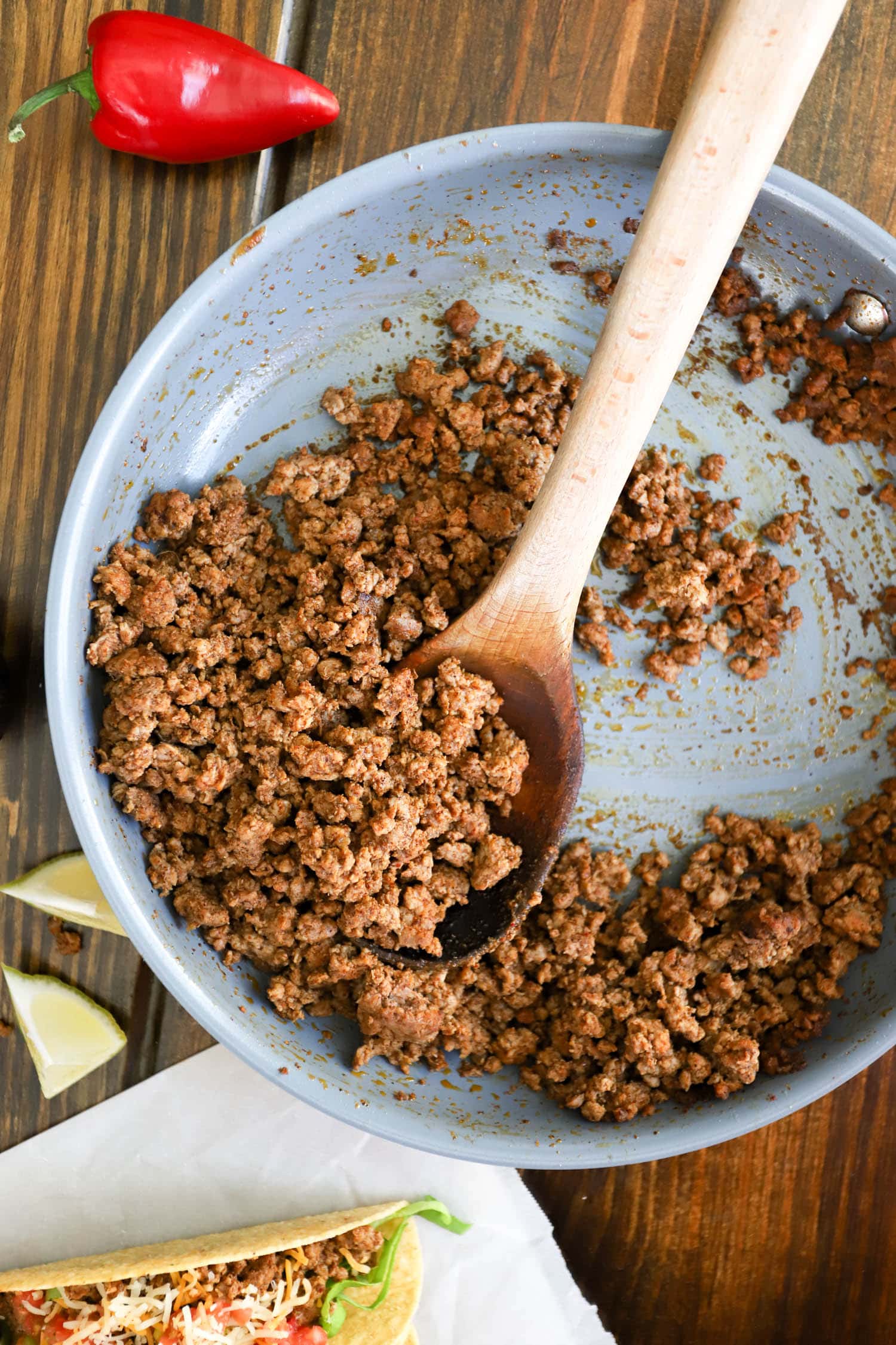 skillet seared mexican ground beef with wooden spoon.
