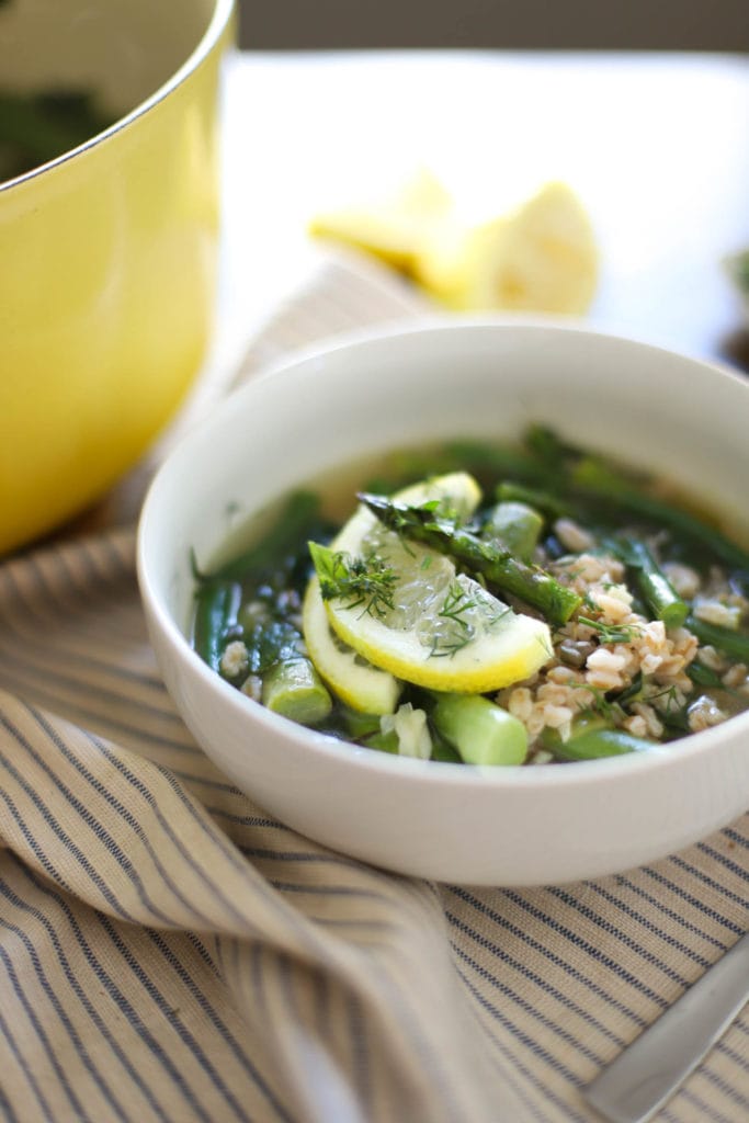spring vegetable soup topped with lemon