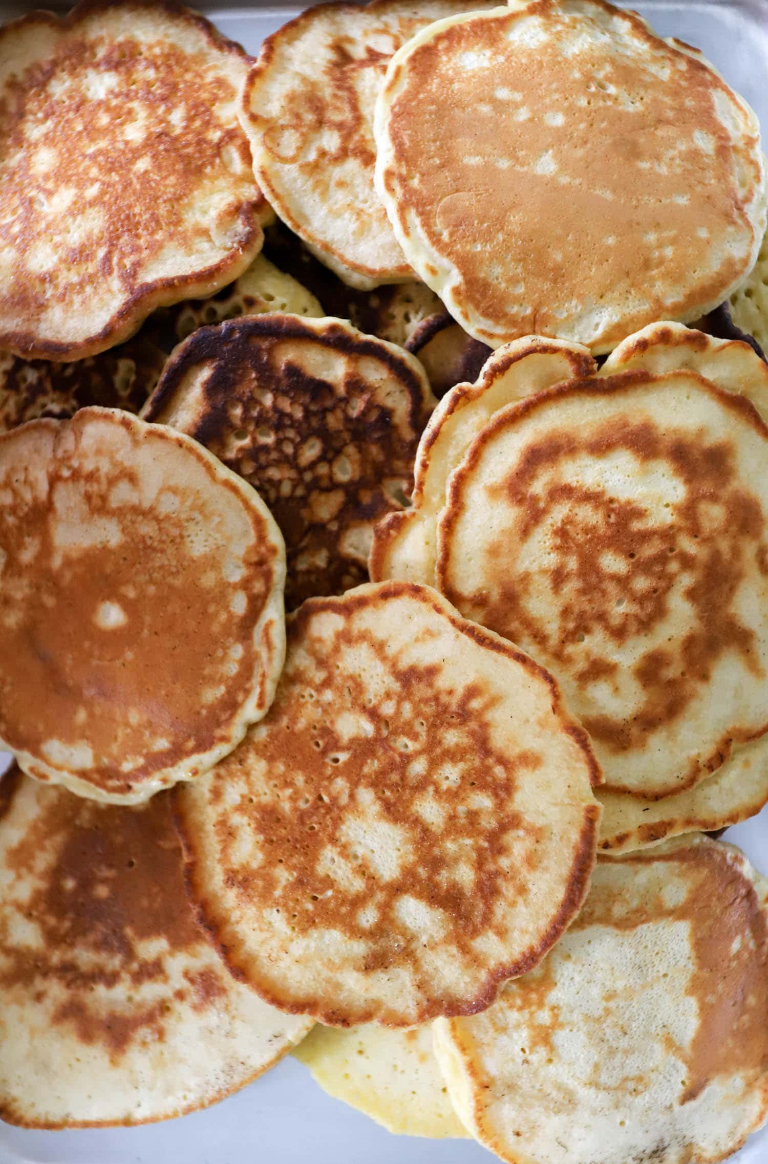 Large pile of Mark Bittman's pancakes close up top view.