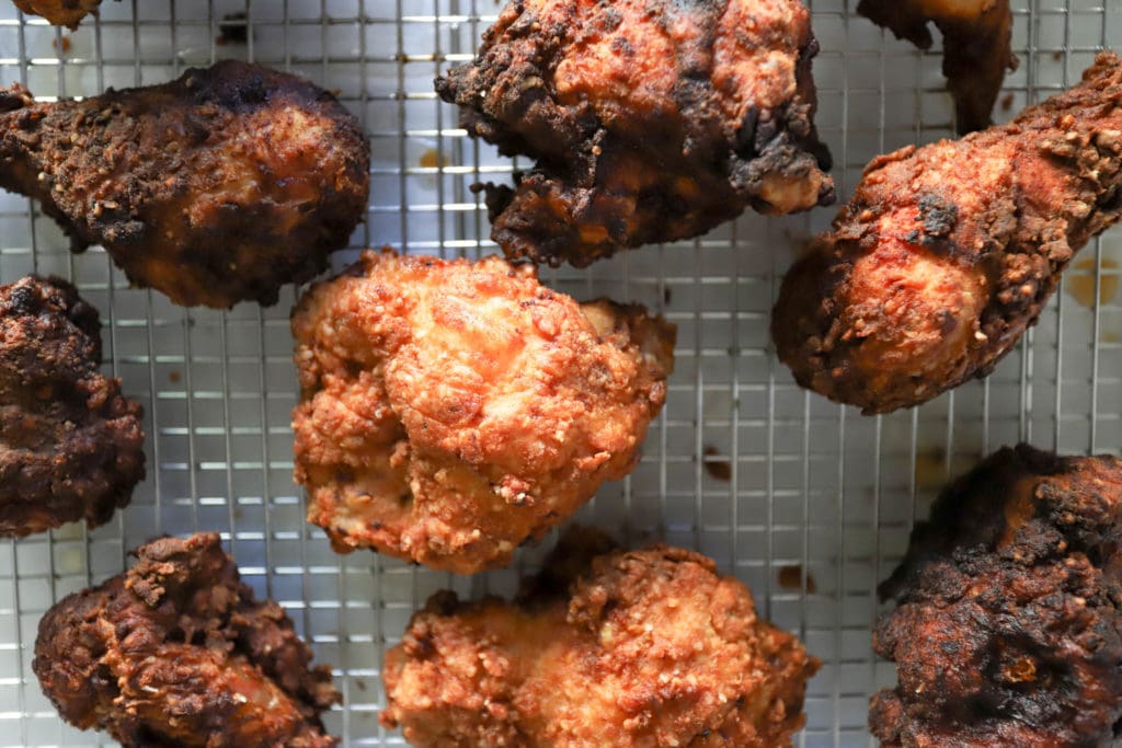 fried bone in chicken pieces top view on rack