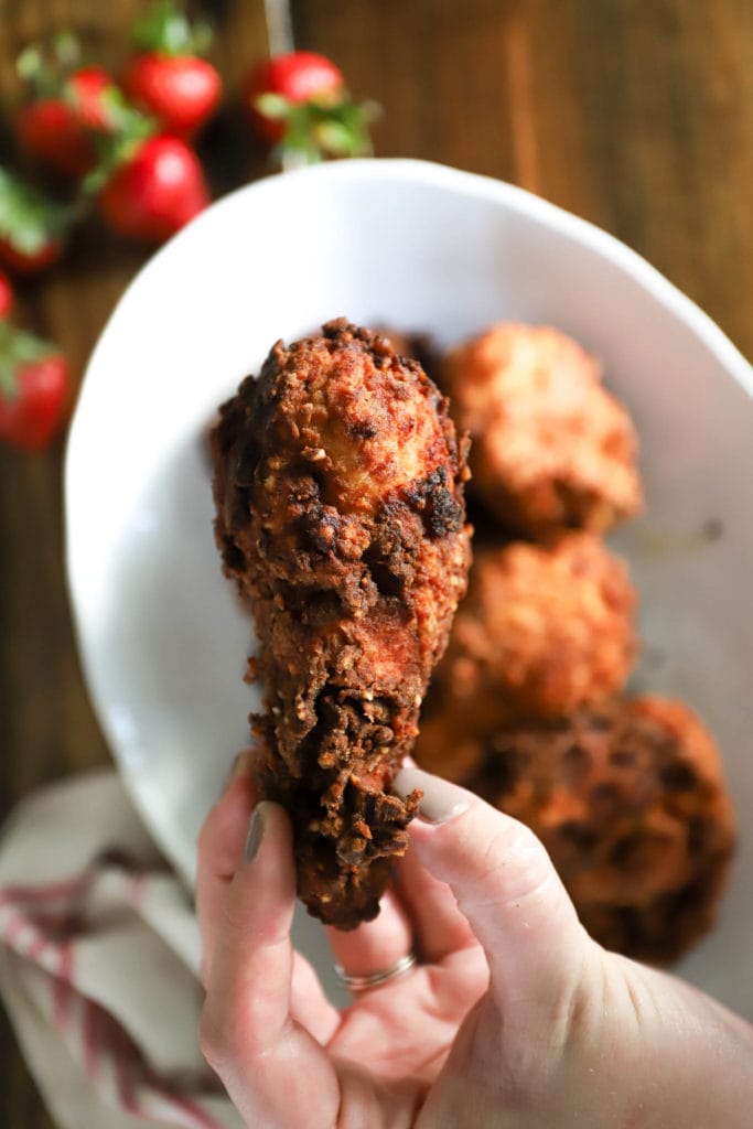 hand holding fried drumstick