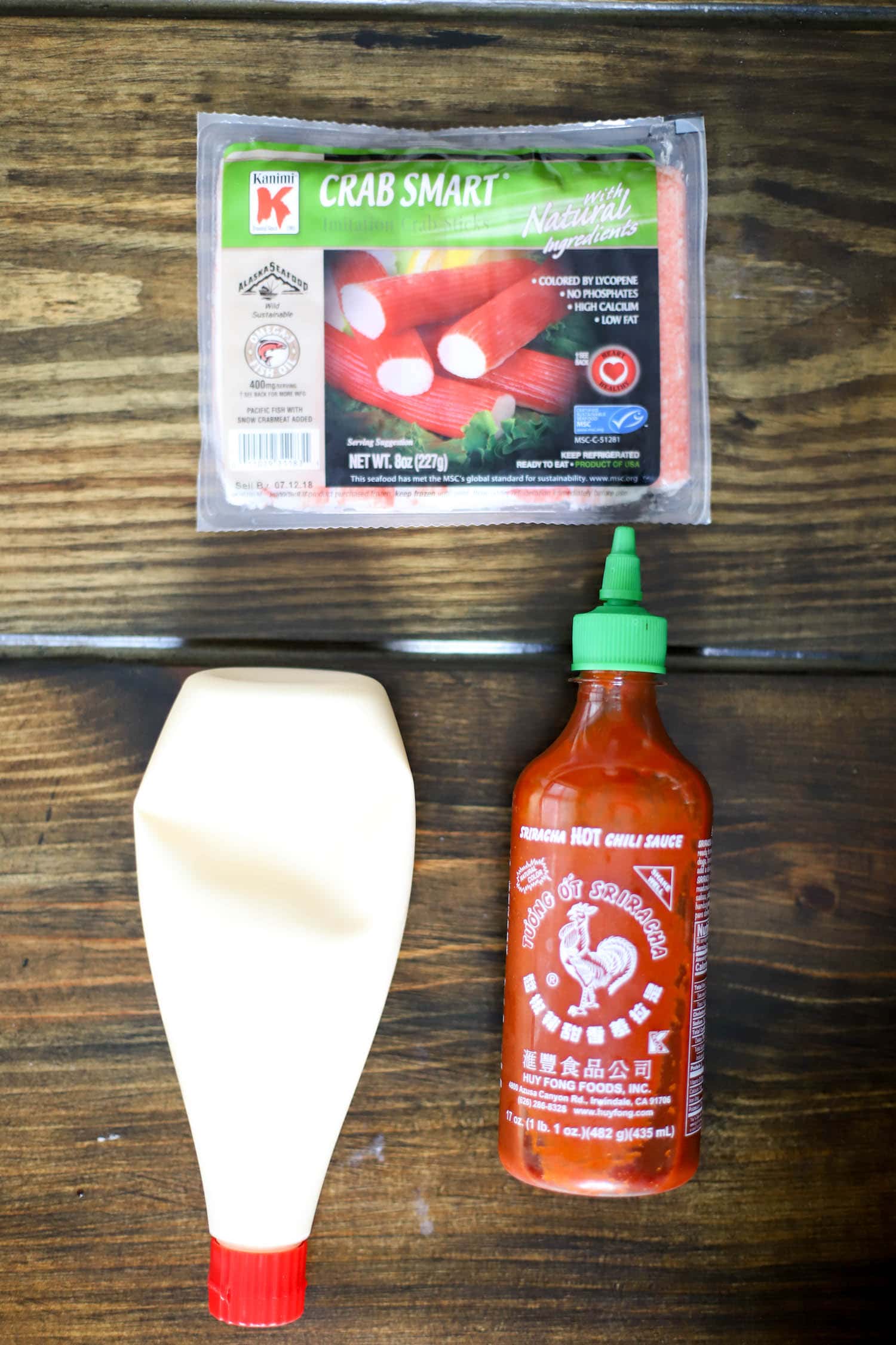 ingredients for spicy crab salad on brown background.