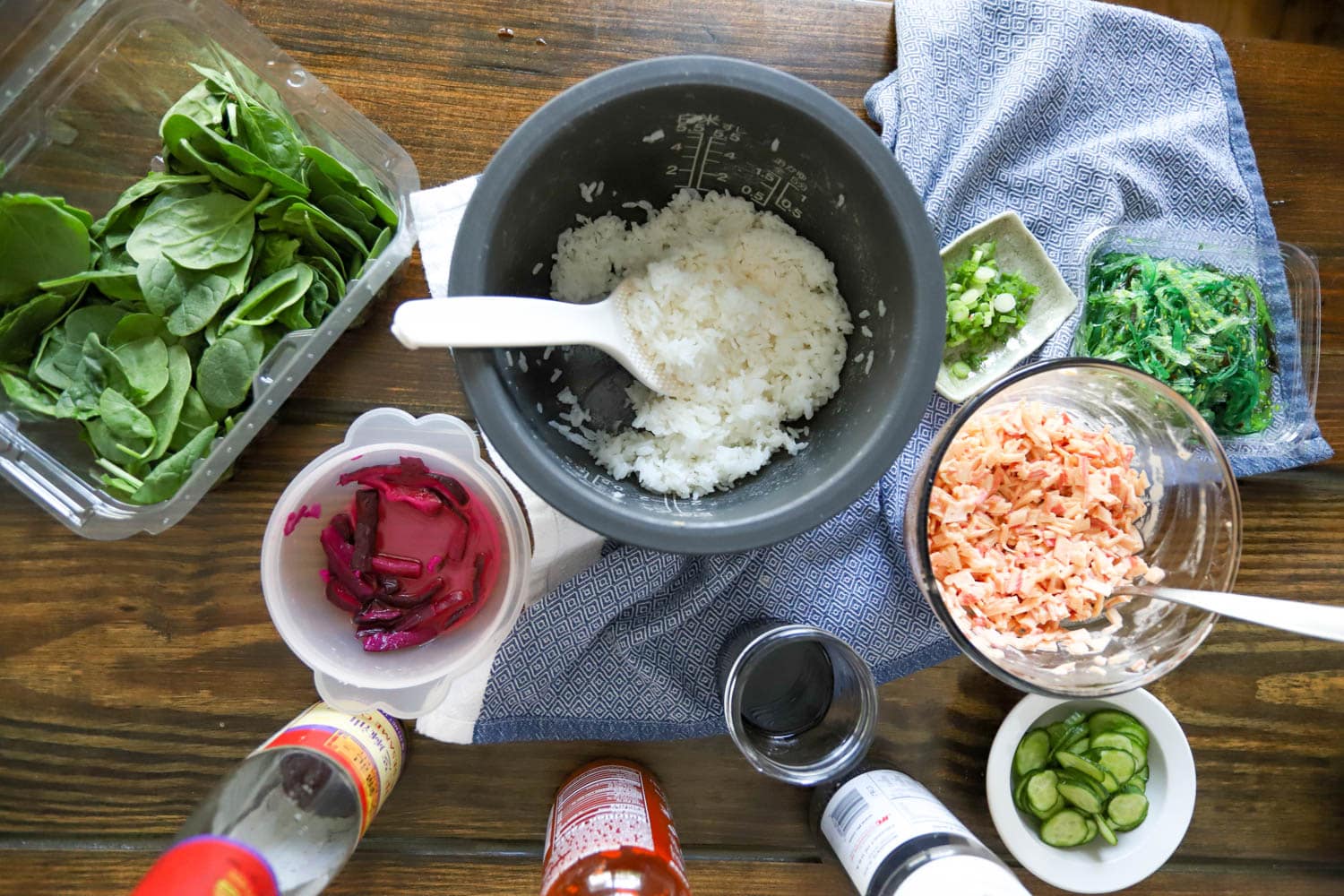 table with ingredients for homemade poke bowls.