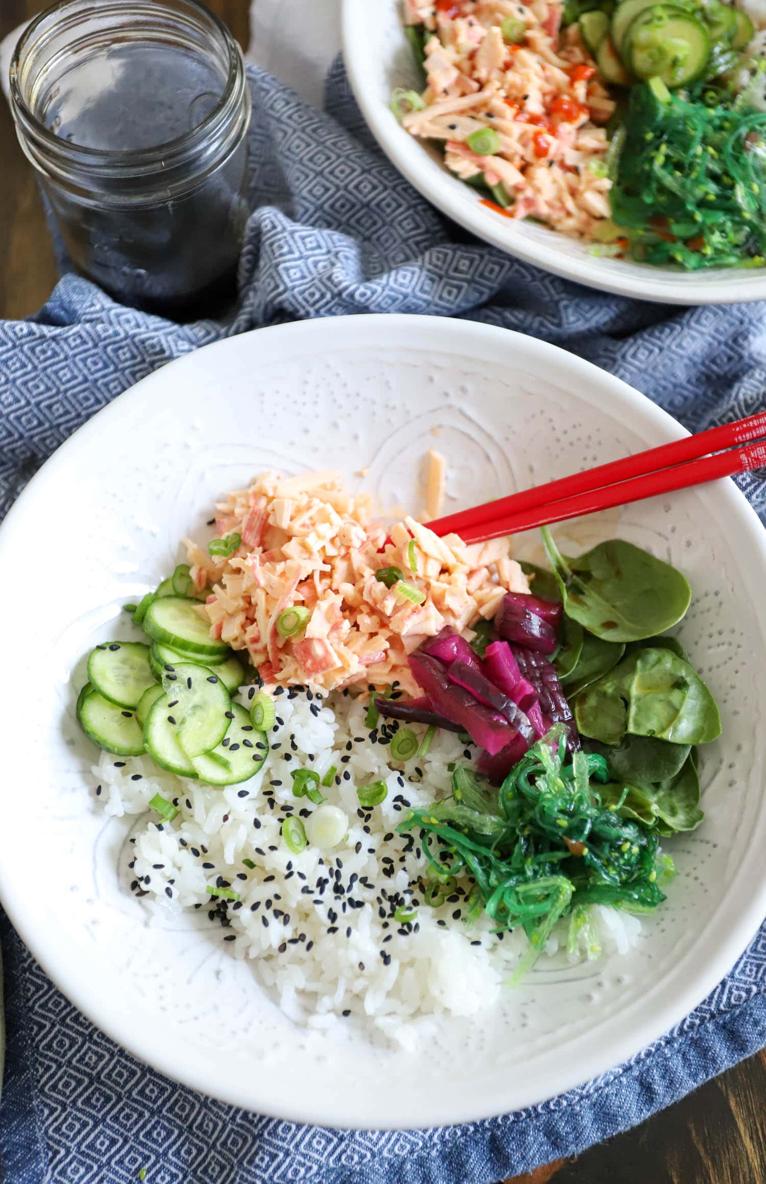 Spicy Crab Poke Bowl over blue napkin in large white bowl.