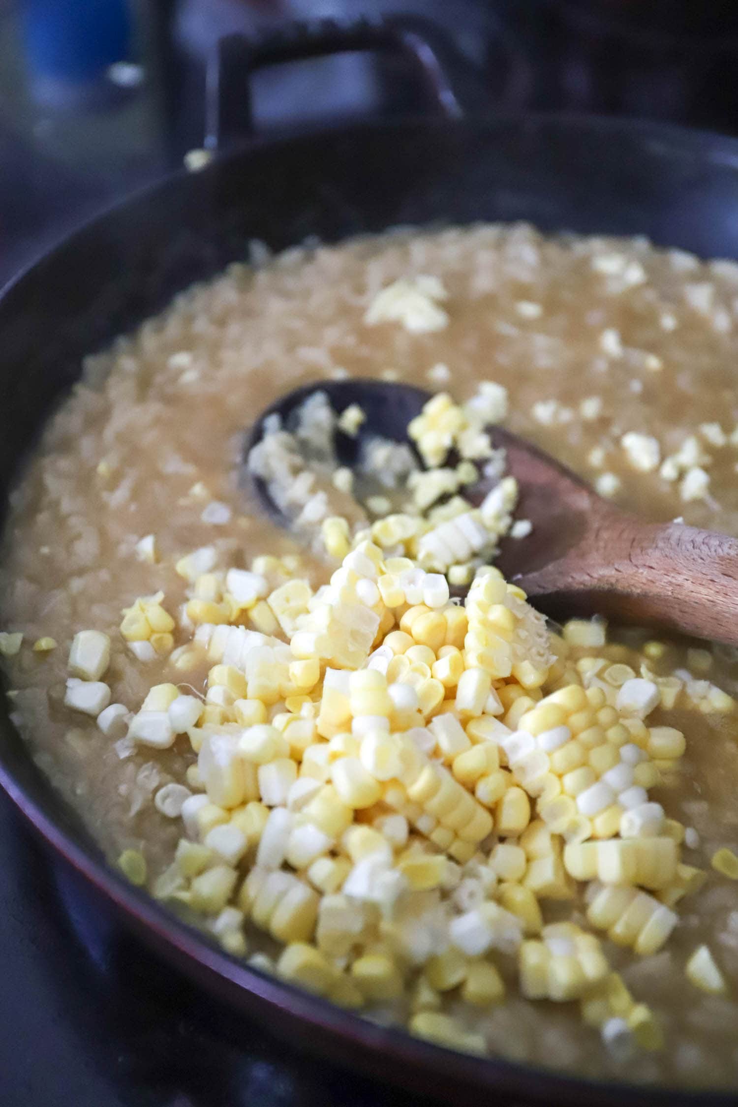 skillet with risotto and fresh corn