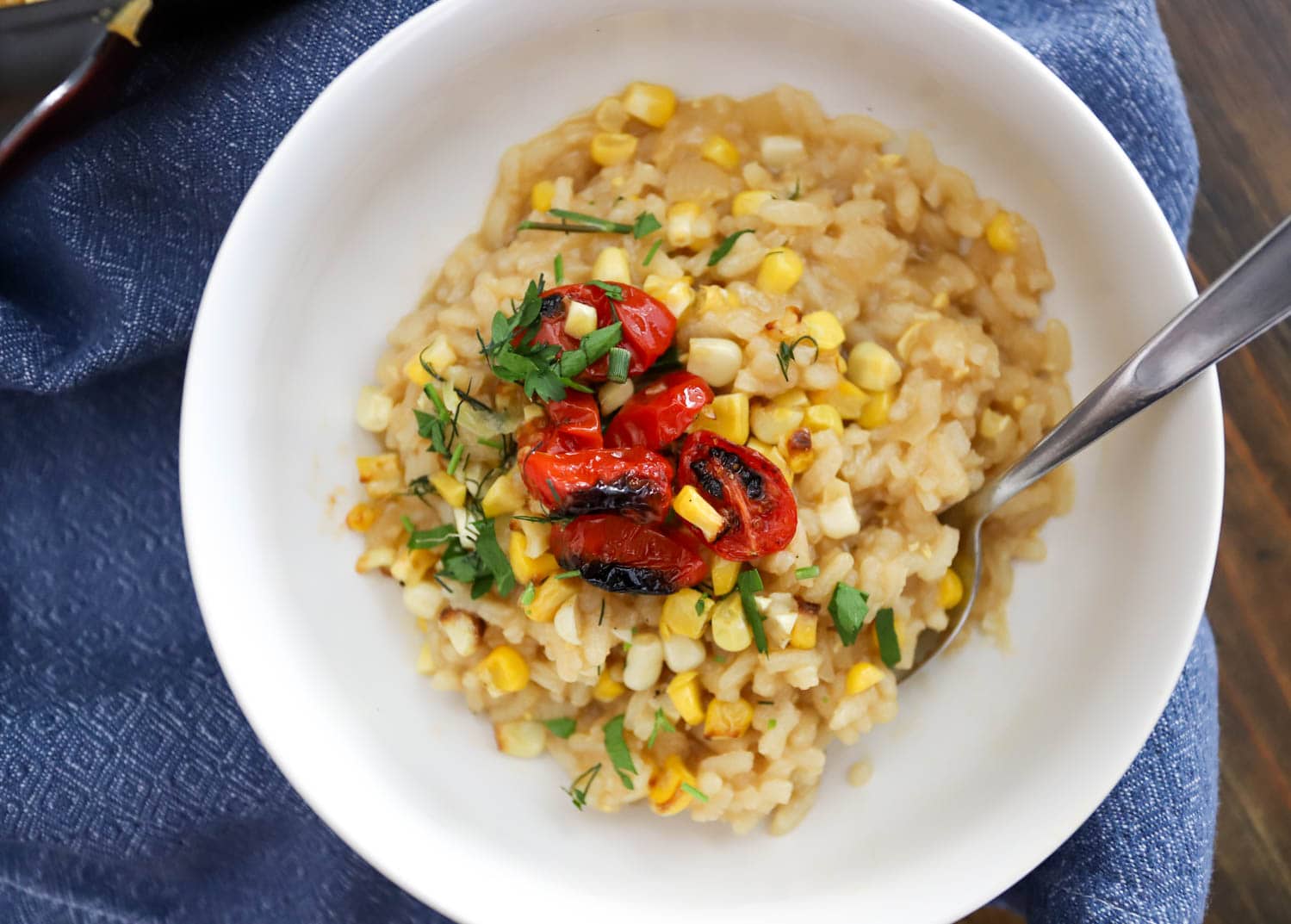 bowl of corn risotto and tomatoes