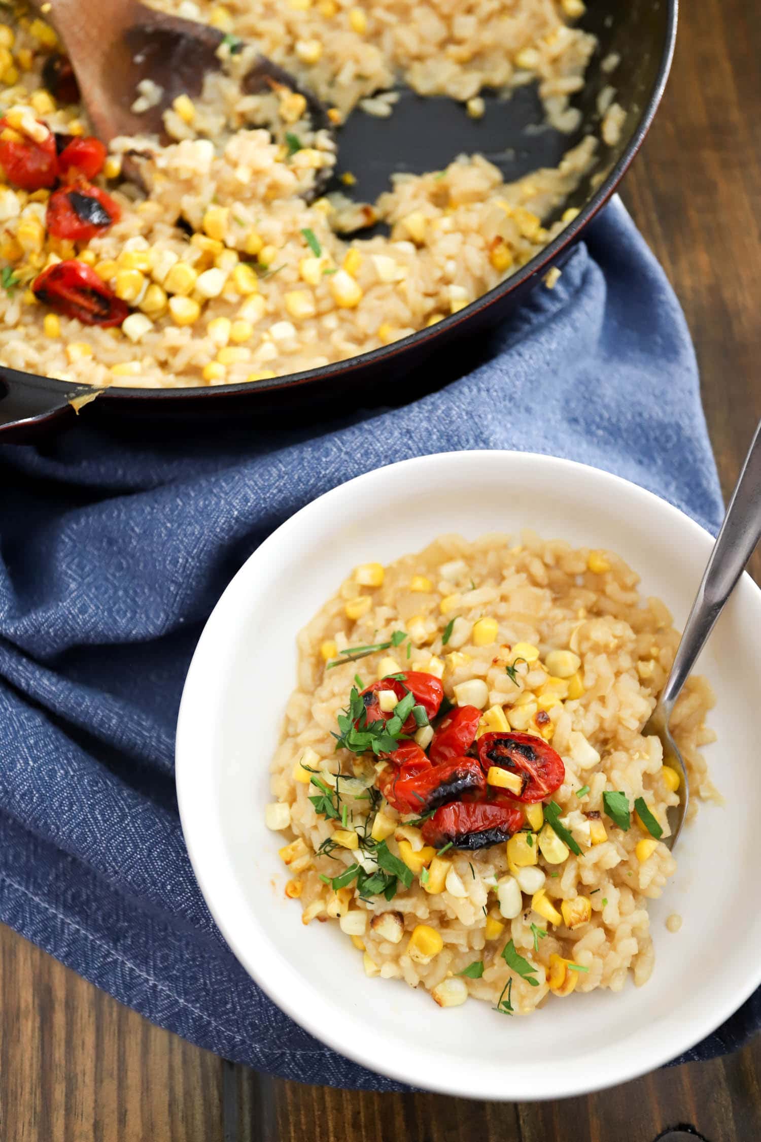 summer corn risotto with blistered cherry tomatoes in bowl