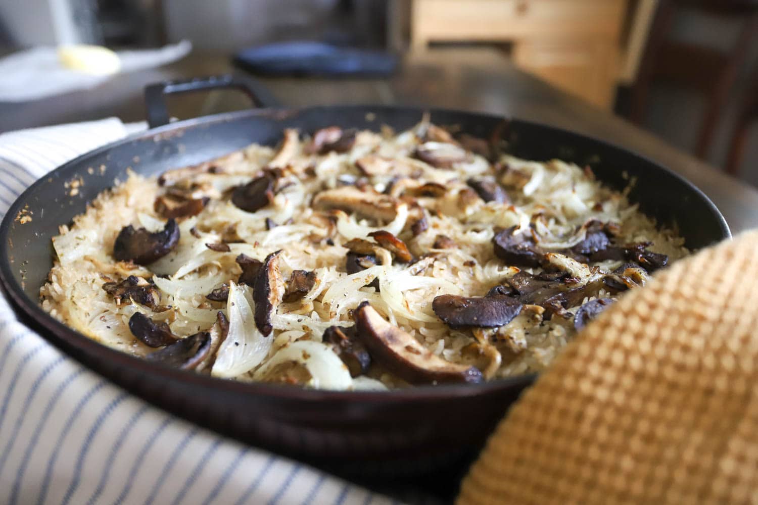 side view of mushrooms topping baked rice casserole.