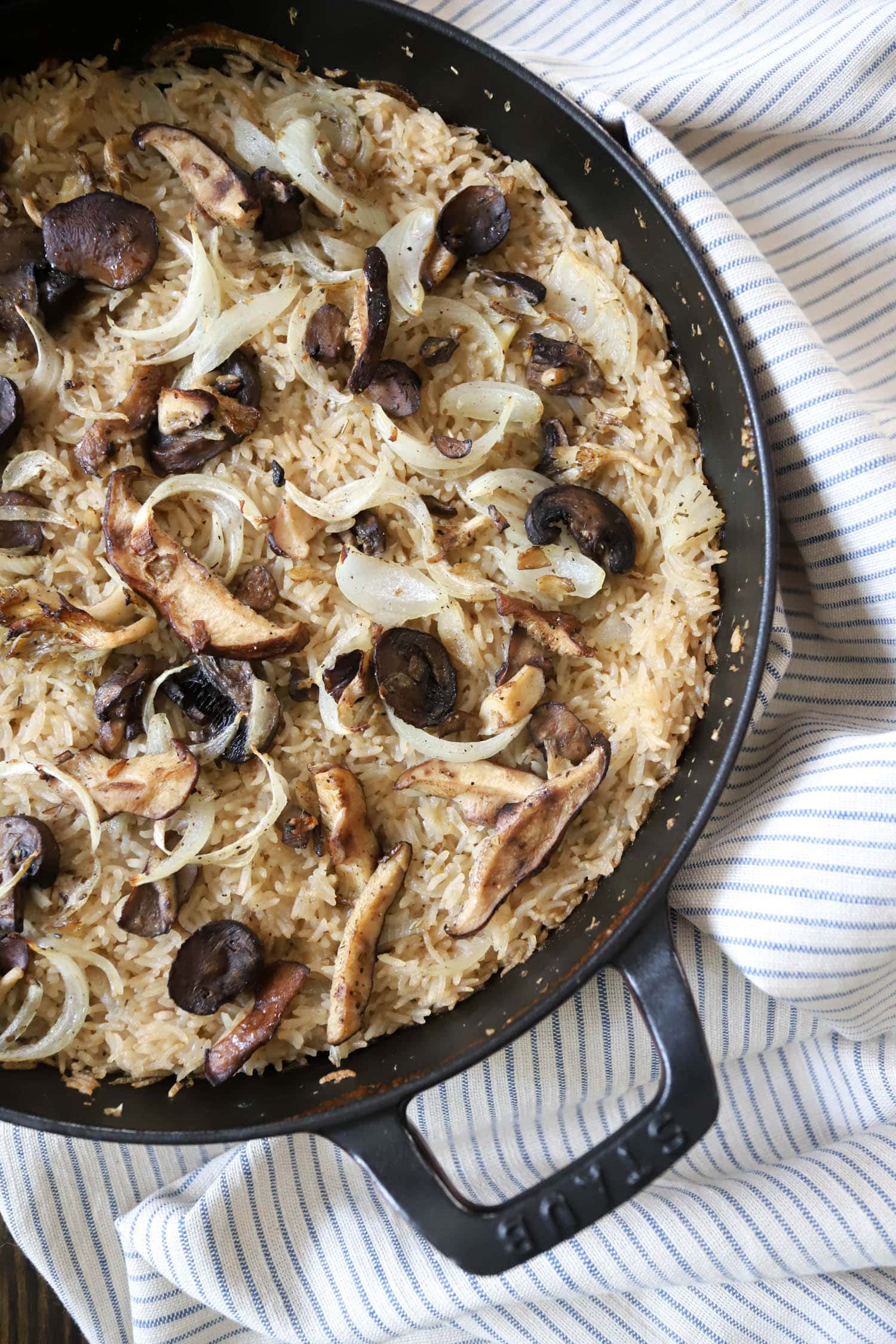 top view of stick of butter rice with onions and mushrooms.