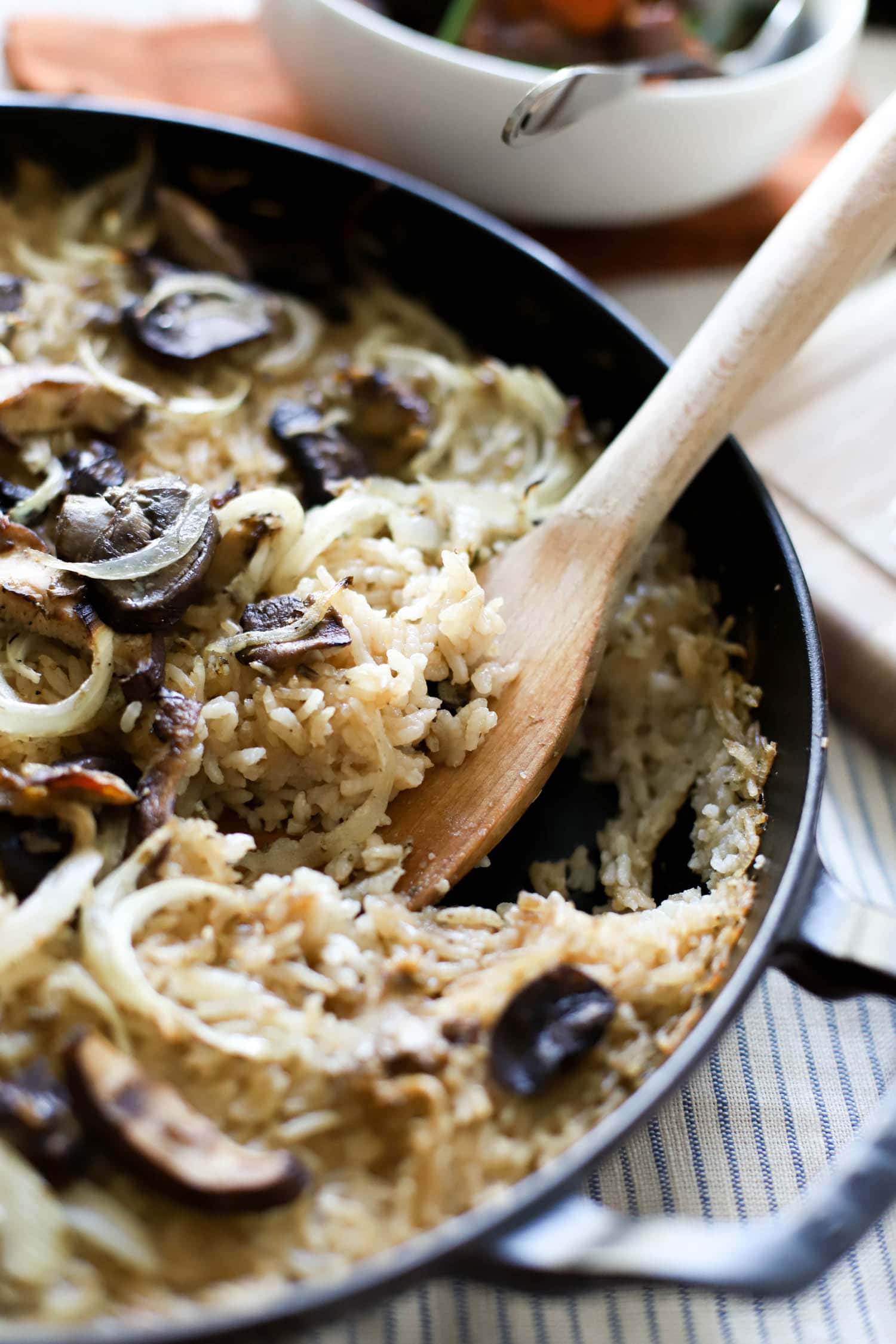 spoon in a pan of mushroom rice casserole.