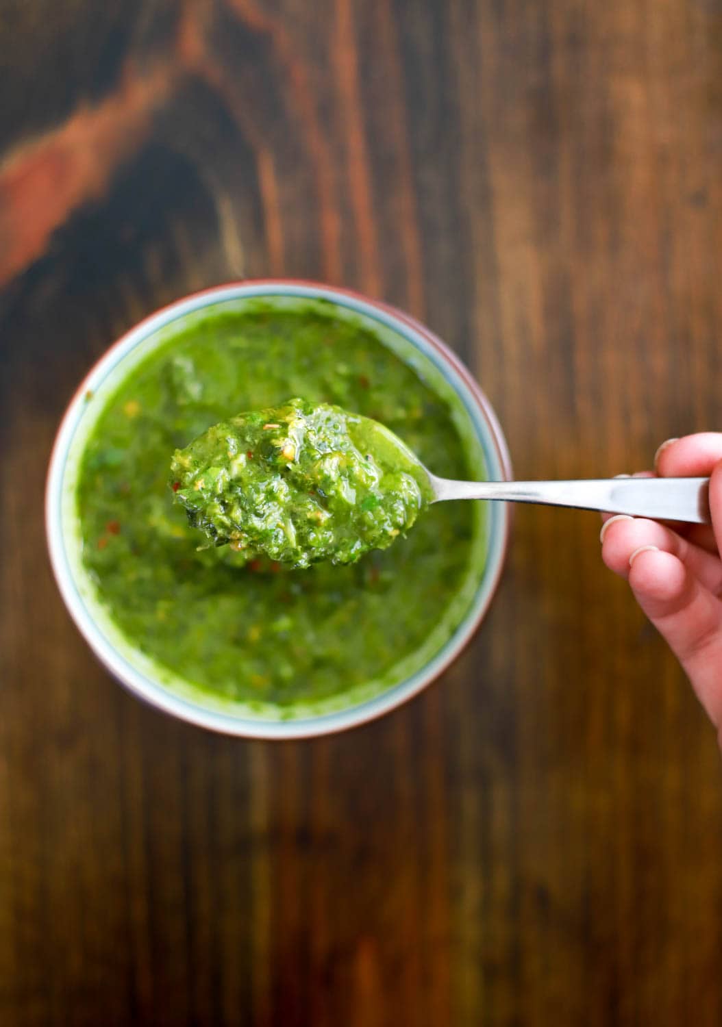 bowl of dairy free basil sauce with spoon