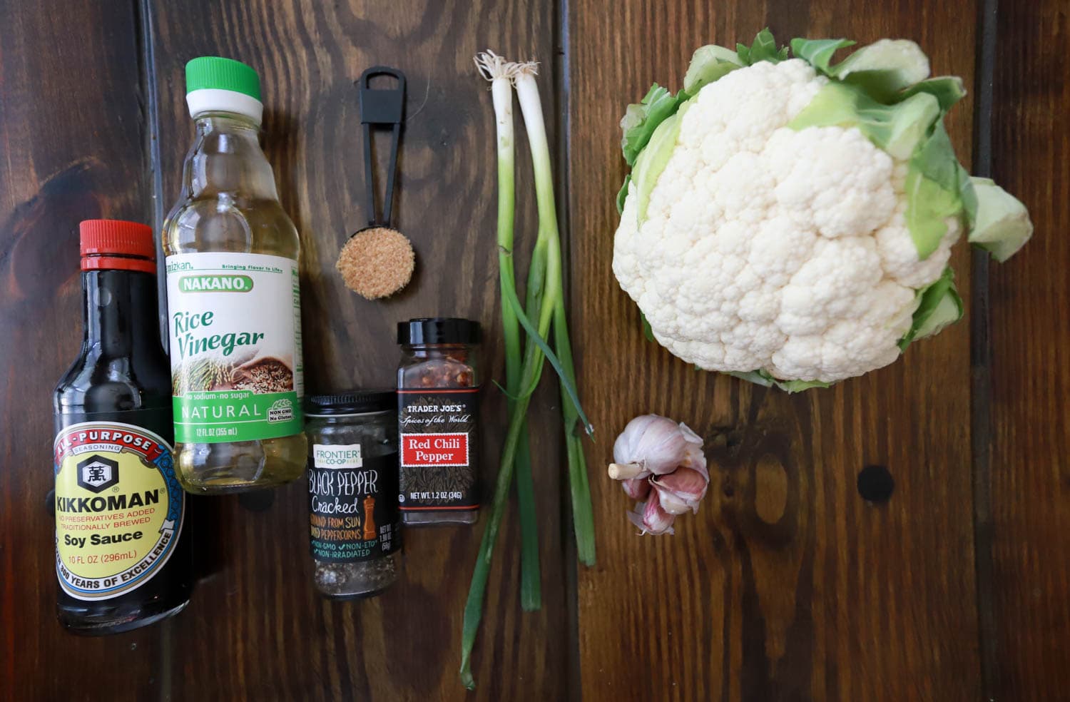 ingredients for adobo cauliflower on brown wood board.
