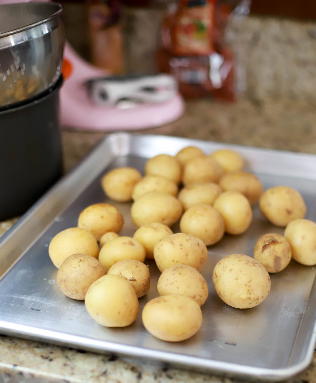 baking sheet of boiled tiny potatoes.