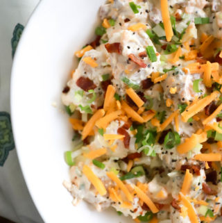 Top view of loaded potato salad recipe with bacon and cheese on top.