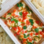 baking pan of hot bean dip topped with cheese and tomatoes.