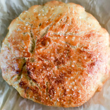 Round loaf of no-knead bread crusted in salt.