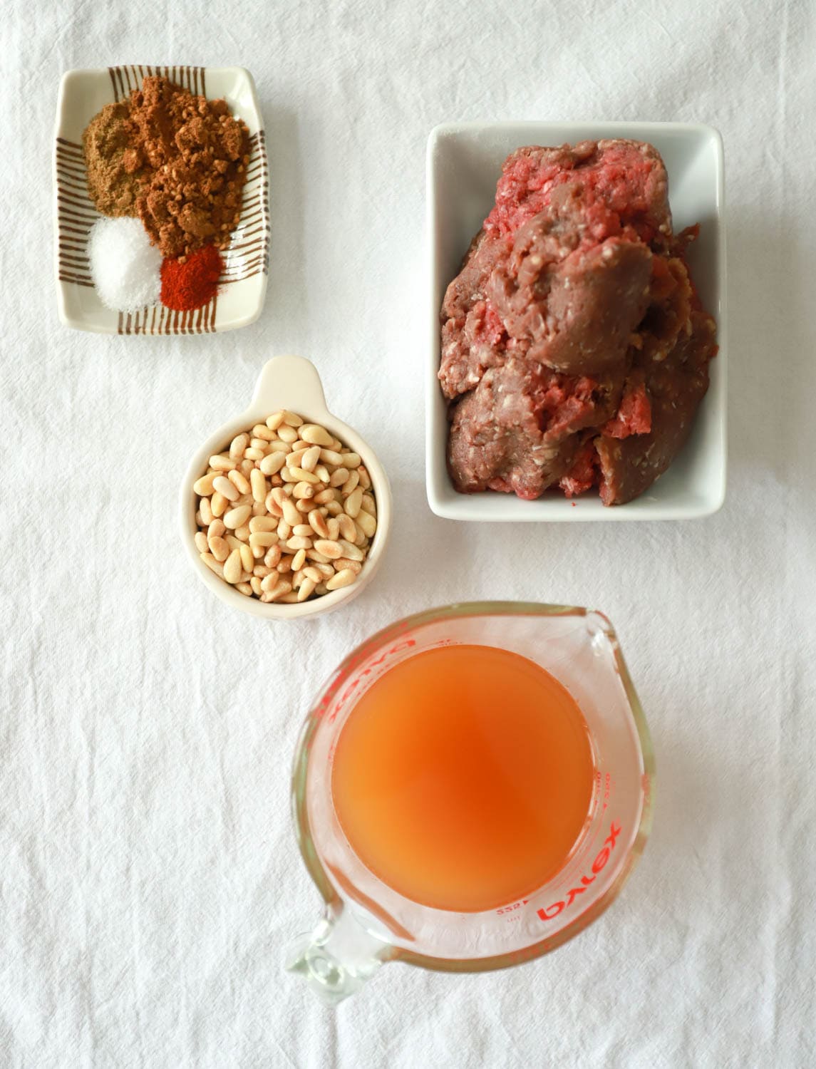 Spiced Ground Meat with Pine Nuts over Hummus Recipe