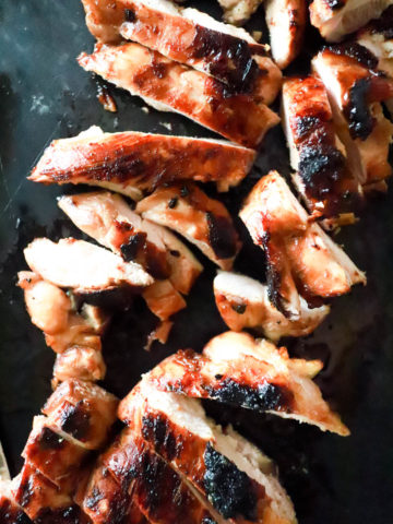 Close up pieces of sliced grilled marinated chicken.