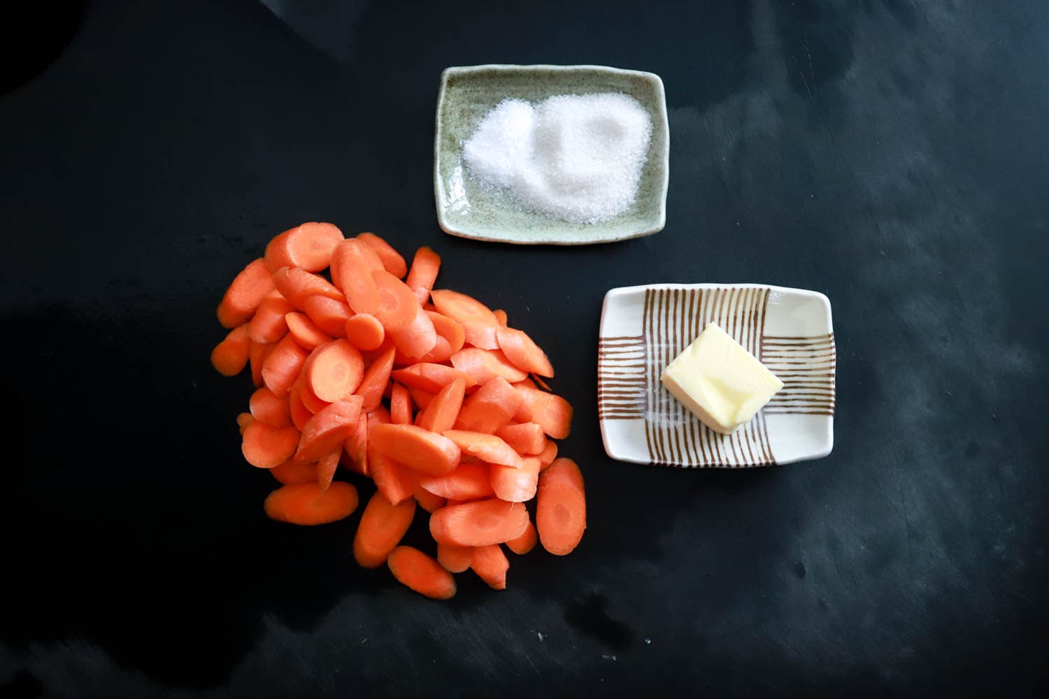 sweet carrots ingredients on black board.