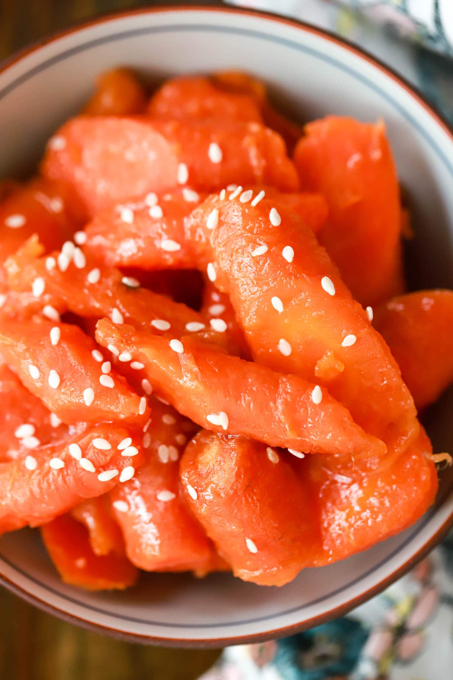 Close up japanese sweet carrots sprinkled with sesame seeds.