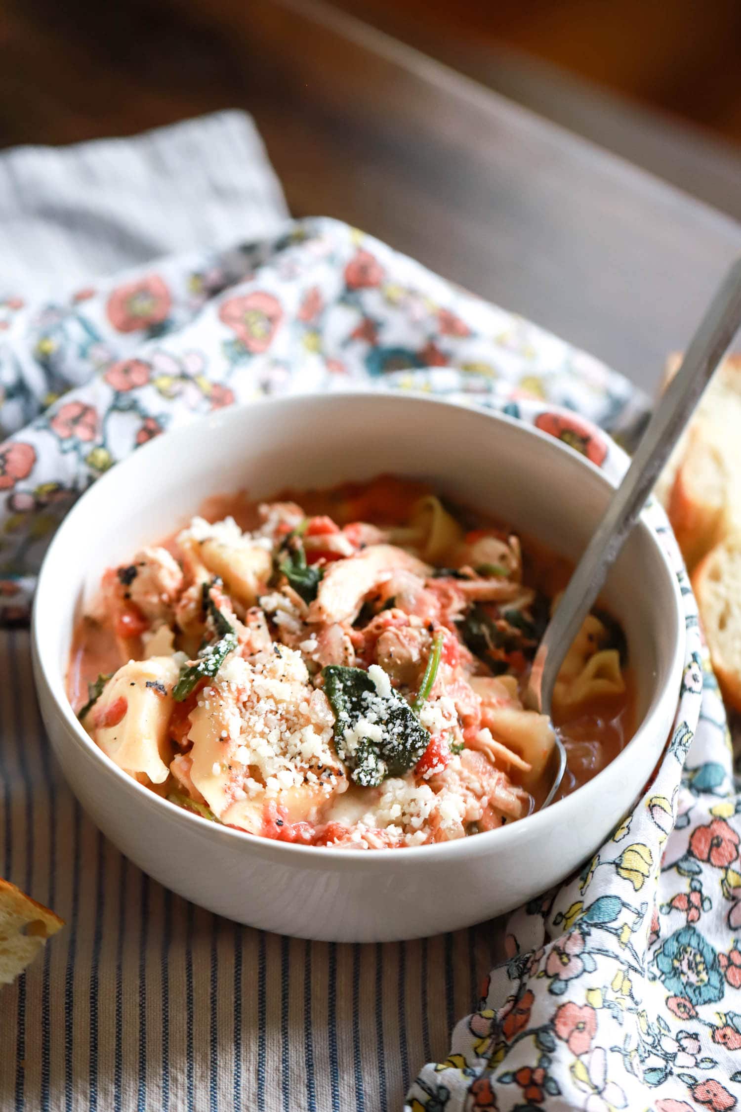 backlit bowl of tortellini chicken soup