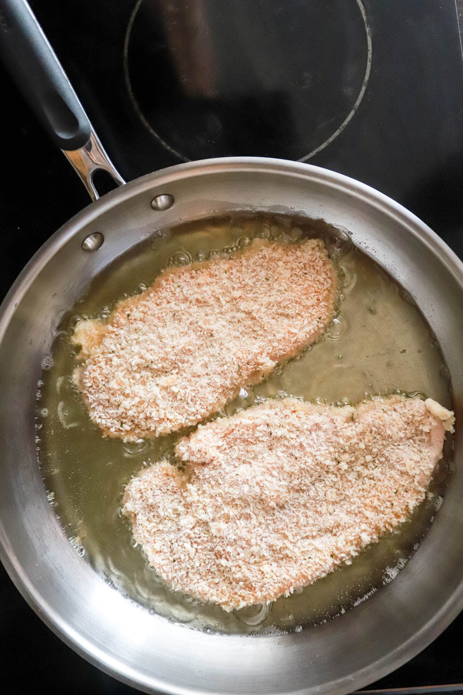 chicken cutlets in frying pan