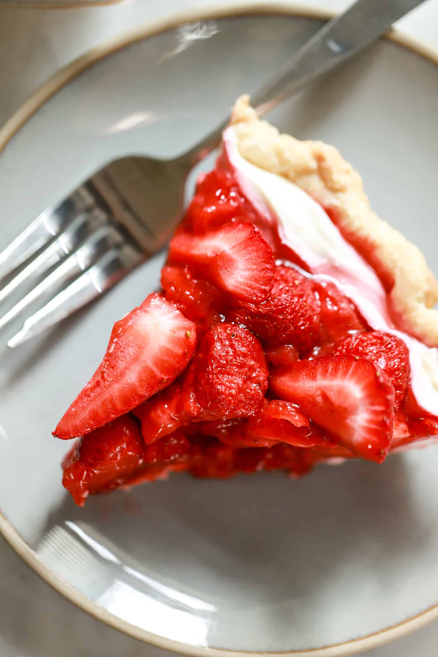 slice of cream cheese strawberry pie with plate and fork