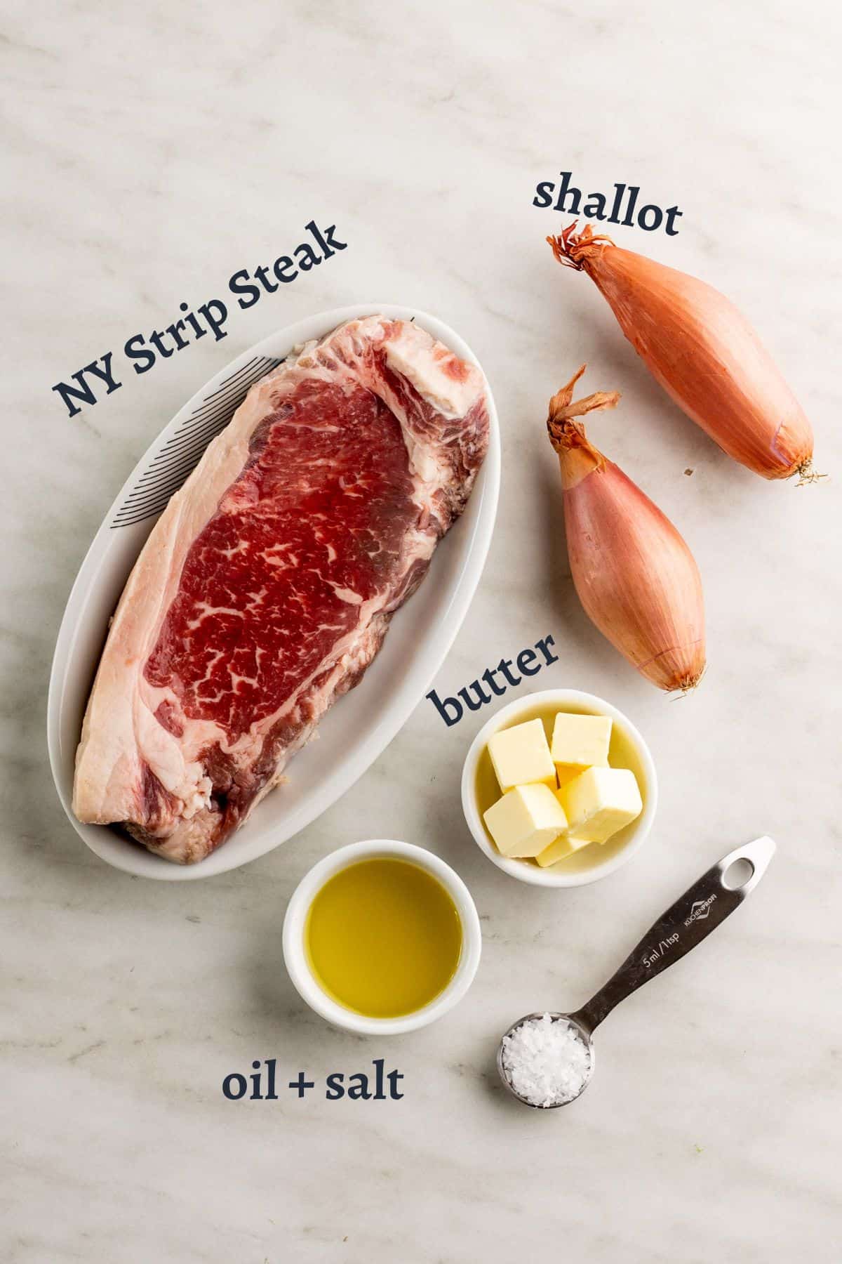Ingredients for seared strip steak on stove.