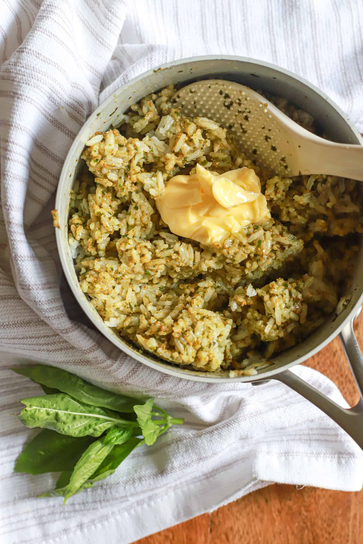 rice with pesto in small pot with pat of butter