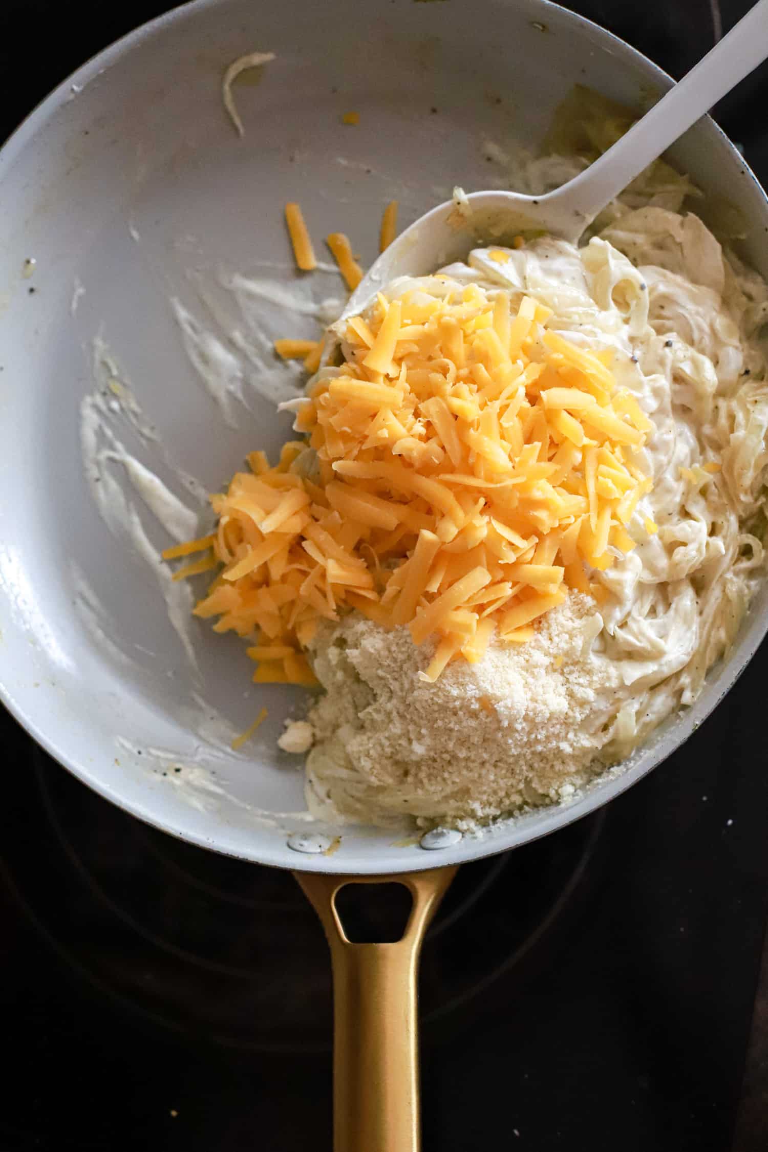 filling for onion casserole in white skillet.