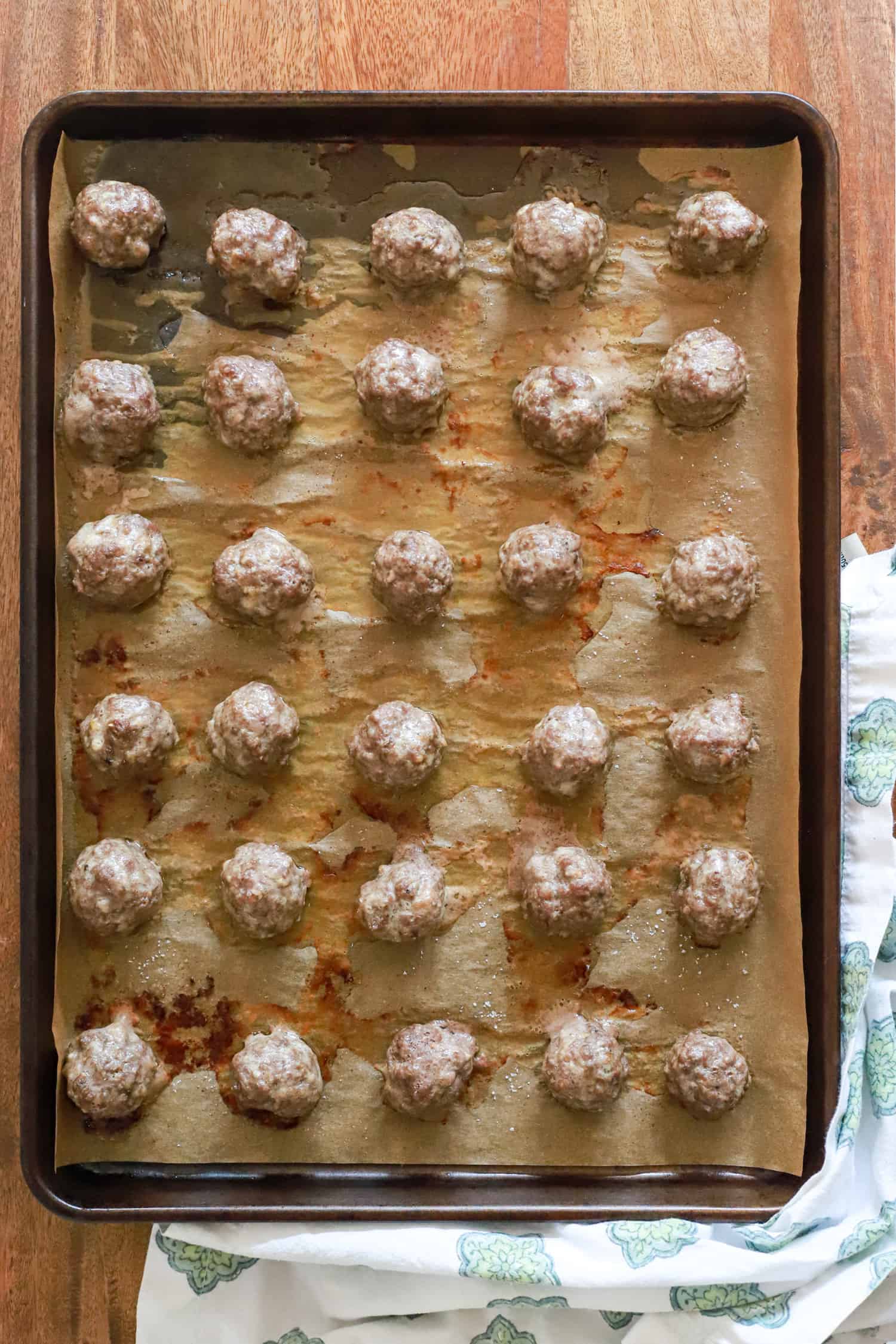 baked greek meatballs on a baking sheet.