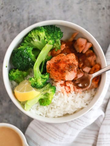 white bowl with blackened salmon, rice, and broccoli