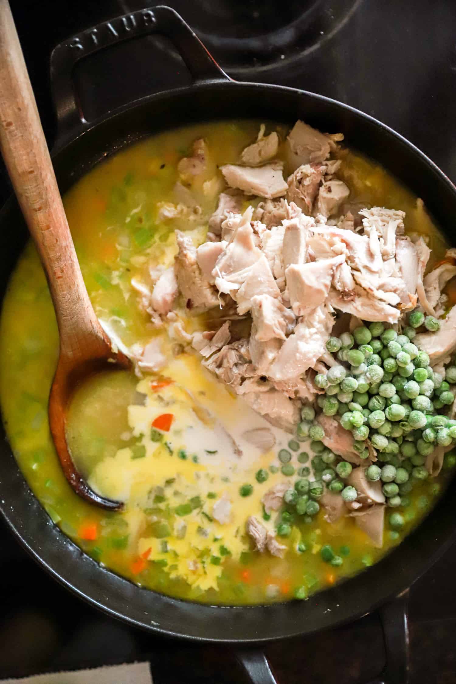 spoonful of peas and turkey on top of pot pie filling.