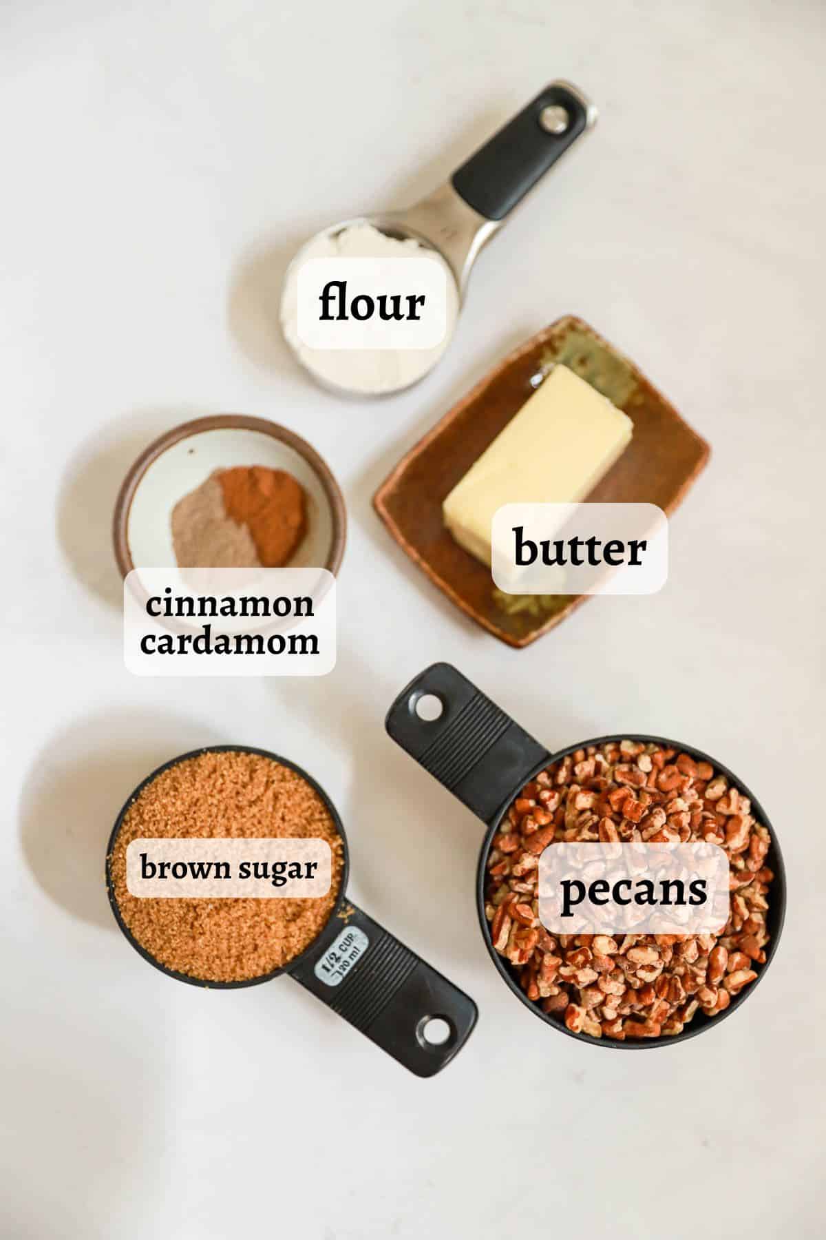 Labeled ingredients for pecan topping for casseroles on white table.